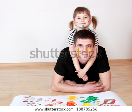 Dad and daughter drawing with colored finger paint