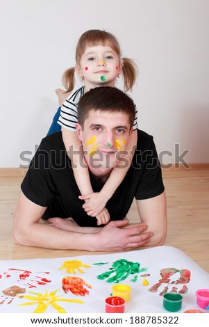 Dad and daughter drawing with colored finger paint