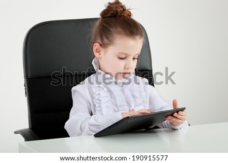Little Girl Reading from Tablet Computer, Isolated on White