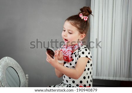 cute smiling little girl with makeup brush