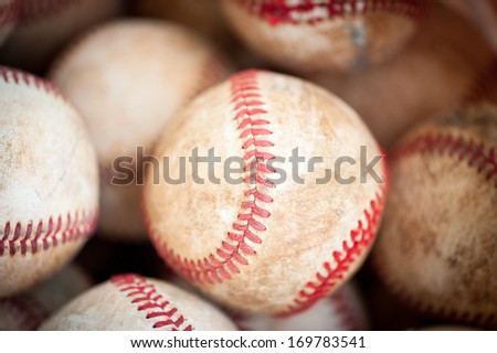 closeup of old practice baseballs