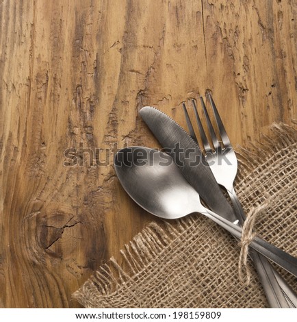 Flatware set of fork, spoon and knife on old wooden table