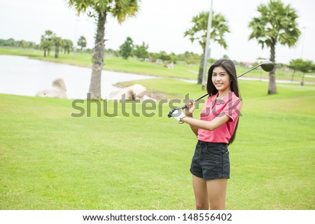 Golf girl with driver at green