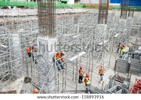 Worker to erect scaffolding on construction site