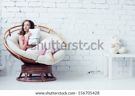 Beautiful young woman in white interior