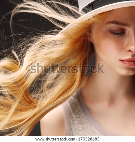 Portrait of a beautiful blonde girl with fluttering hair