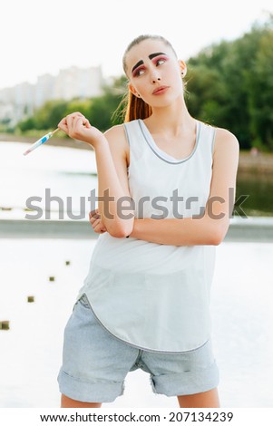 Emotional portrait of a beautiful young girl with candy outdoor lifestyle