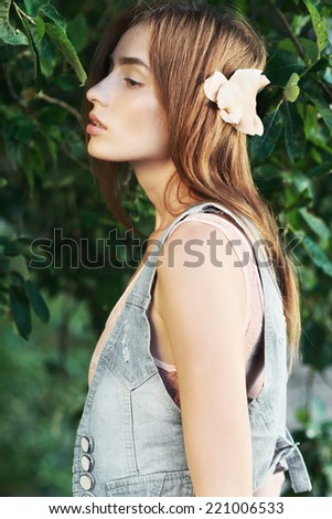 Portrait of beautiful girl in fashionable clothes, standing in profile, lifestyle