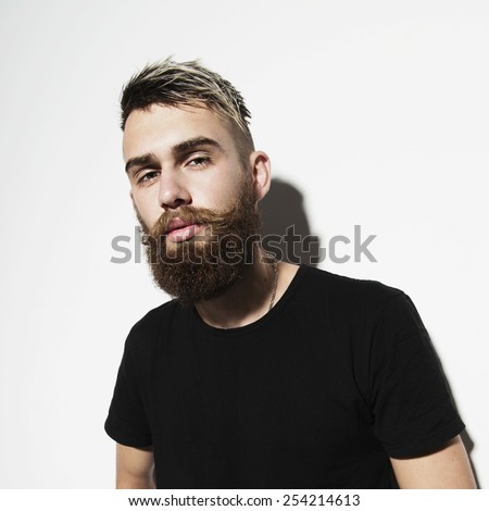 Portrait of a young bearded man on a white background