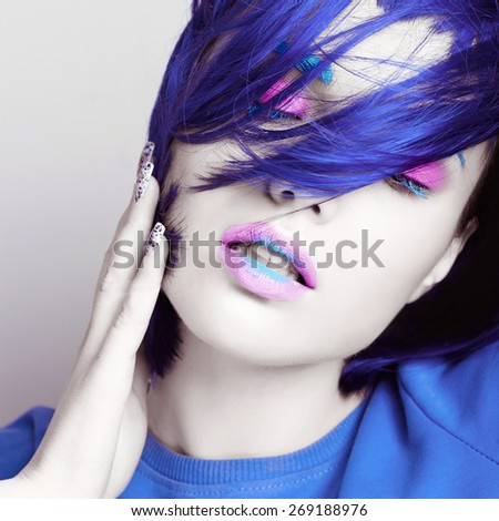 Portrait of beautiful girl with blue hair and white skin with closed eyes in studio, close up