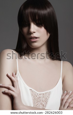 Beautiful and delicate girl in the studio on a gray background, the concept of beauty and health