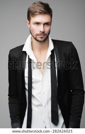Portrait of handsome stylish man in a suit in the studio