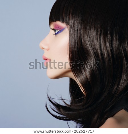 Beautiful young girl in the studio face in profile close-up, beauty concept