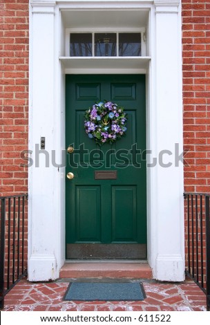 welcoming door with flower wreath