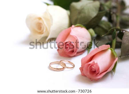 wedding rings and roses on white with space for writing (wedding invitation card )