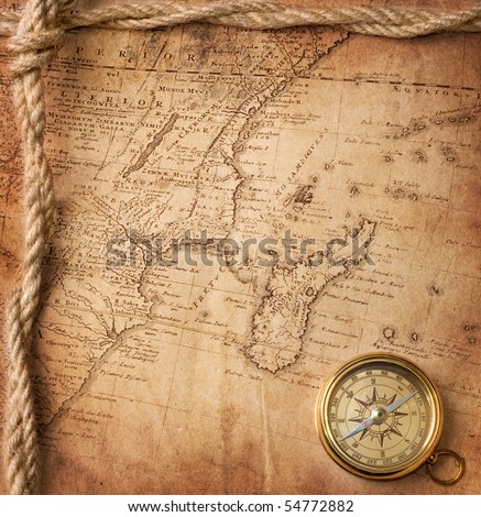 old compass and rope on vintage map