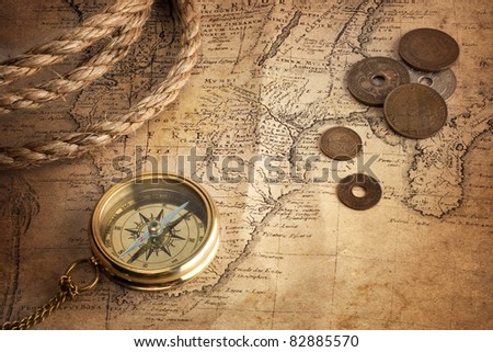 old compass, old coins and rope on vintage map ( Africa 18 century author Ion.  Matthia Hasio)