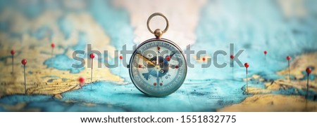 Magnetic compass  and location marking with a pin on routes on world map. Adventure, discovery, navigation, communication, logistics, geography, transport and travel theme concept background. ストックフォト © 