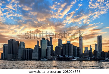 New York Skyline with powerful backlit cloudy sunset