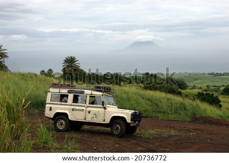 Safari Truck off road with Volcanic Island in the background