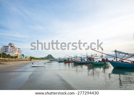 Prachuap Khiri Khan, Thailand - May 3, 2015: Group of fishing boats at the coast in the morning on May 3, 2015 in Prachuap Khiri Khan Province, Thailand