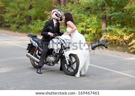 Wedding couple having fun on motorcycle.