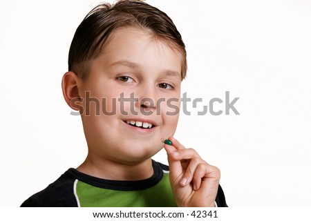 Boy with medicine capsule