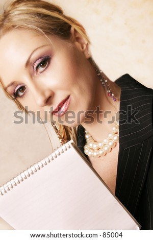 Lady holds a small memo pad.