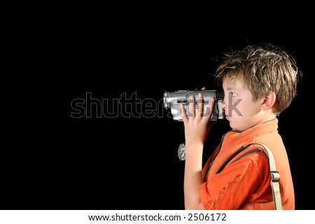 Boy filming using a home video camera,  camcorder. Space for text.