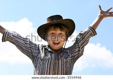 Experience country life.   An excited country rural boy jumps for joy in the fresh country air,
