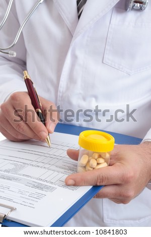 A medical healthcare  doctor with  health records and medicine.  Focus to hand with pills
