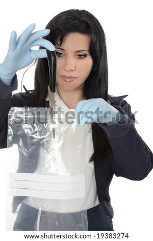 A woman detective collects a blood stained knife from a crime scene