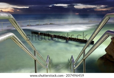 Bronte Baths, ocean pool Sydney.  Waves surge into the pool constantly.  Focus is to hand rails.  Buyers this is a long 8 sec exposure taken 1 hr before sunrise at 500 iso,  there may be some grain