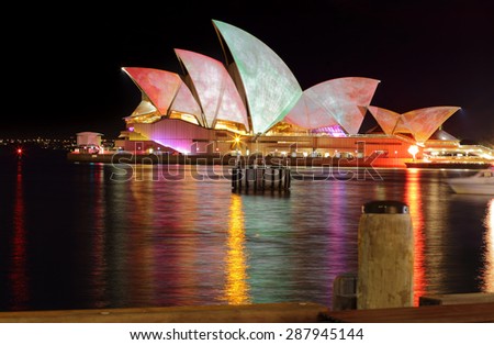 SYDNEY, AUSTRALIA - MAY 27, 2015; The Sydney Opera House during Vivid Sydney annual festival.  Coloured lights and patterns shine on the roof like these watercolours from a long exposure.