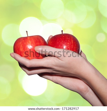 female hands holding apples