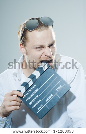 young man with movie clapper