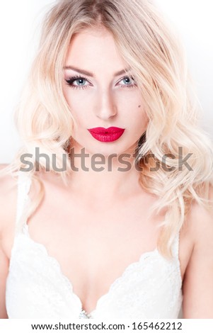 glamor closeup portrait of beautiful sexy blonde model with bright makeup, with red lips, with perfect clean skin in studio