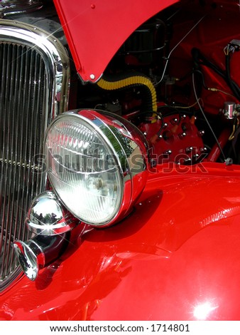 Head light, horn, grill and engine in antique red 1933 coupe