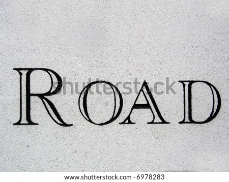 Fancy lettered road sign chiseled into stone