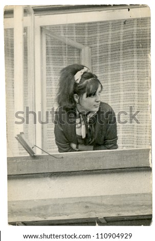Eastern Bohemia, CZECHOSLOVAKIA, CIRCA 1970 - Young woman looking out the window - circa 1970