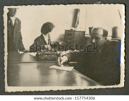 CENTRAL BULGARIA, BULGARIA - CIRCA 1955: the area Plovdiv - Man sitting in the office and writes something on paper - Note: quite blurriness, better at smaller sizes - circa 1955