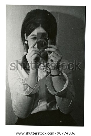 ZVOLEN, SLOVAKIA, 1969 - Miss who does makeup, hair and provides viewing in a small mirror. (A series of six photographs - photographic snapshots.) Image taken in 1969