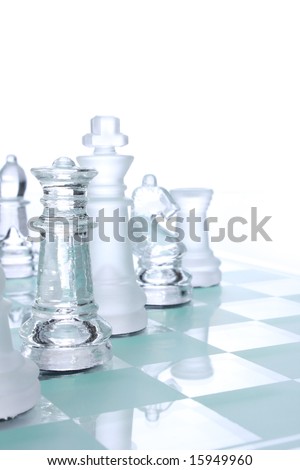 Translucent glass chess figures on a board