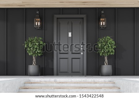 Stylish black front door of modern house with black walls, door mat, trees in pots, stairs and lamps. 3d rendering
