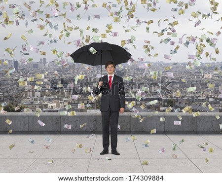 Businessman with an umbrella under the euro rain, roof terrace 2