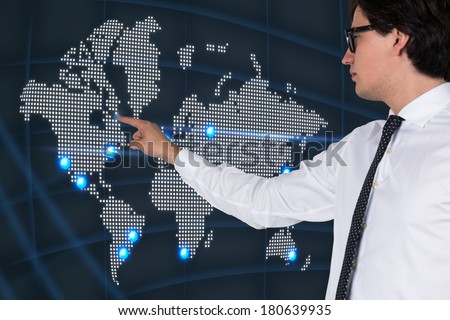 Businessman pointing out to the world map