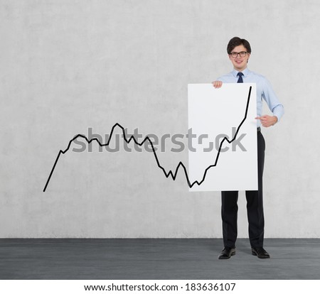 Businessman holding a placard with a line graph 2