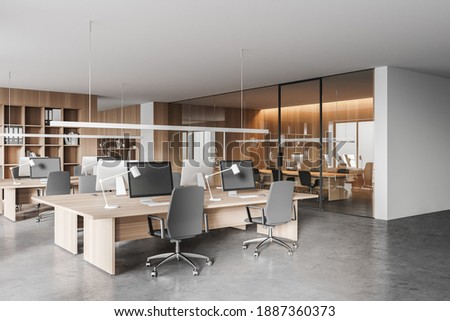 Corner of modern open space office with white and wooden walls, concrete floor and rows of computer tables. Meeting room in the background. 3d rendering ストックフォト © 