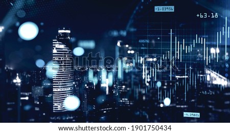 Double exposure of blurry financial graphs over night cityscape background. Concept of trading. Toned image