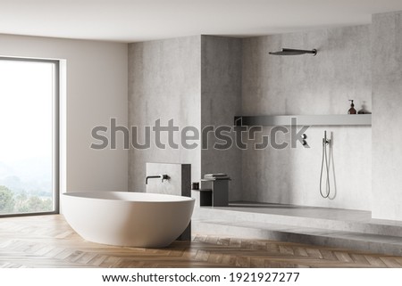 Light grey bathroom with white bathtub and shower near window, side view. Minimalist design of modern grey bathroom with parquet floor 3D rendering, no people